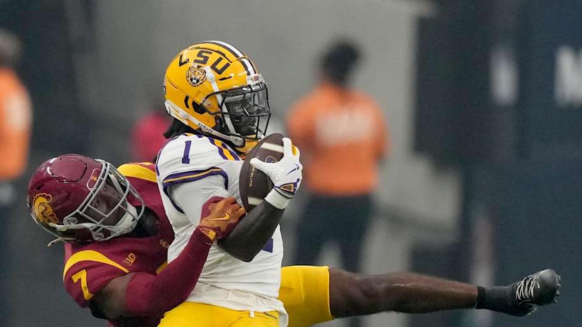  Sep 1, 2024; Paradise, Nevada, USA; LSU Tigers wide receiver Aaron Anderson (1) is tackled by Southern California Trojans safety Kamari Ramsey (7) in the first half at Allegiant Stadium. Mandatory Credit: Kirby Lee-Imagn Images | Kirby Lee-Imagn Images 