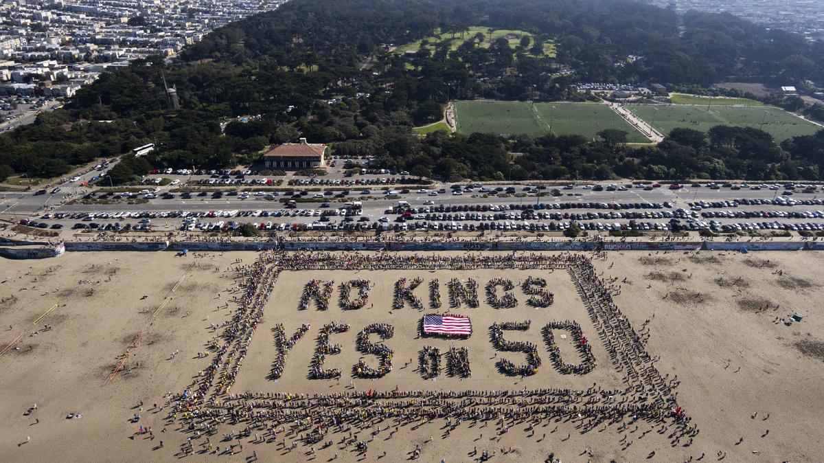 This aerial picture taken on Saturday, Oct. 18, 2025, shows protesters forming a human banner during the "No Kings" national day of protest on Ocean Beach in San Francisco. UC Berkeley law dean Erwin Chemerinsky urges voters to pass Prop. 50 to prevent partisan gerrymandering and preserve checks and fairness in elections.