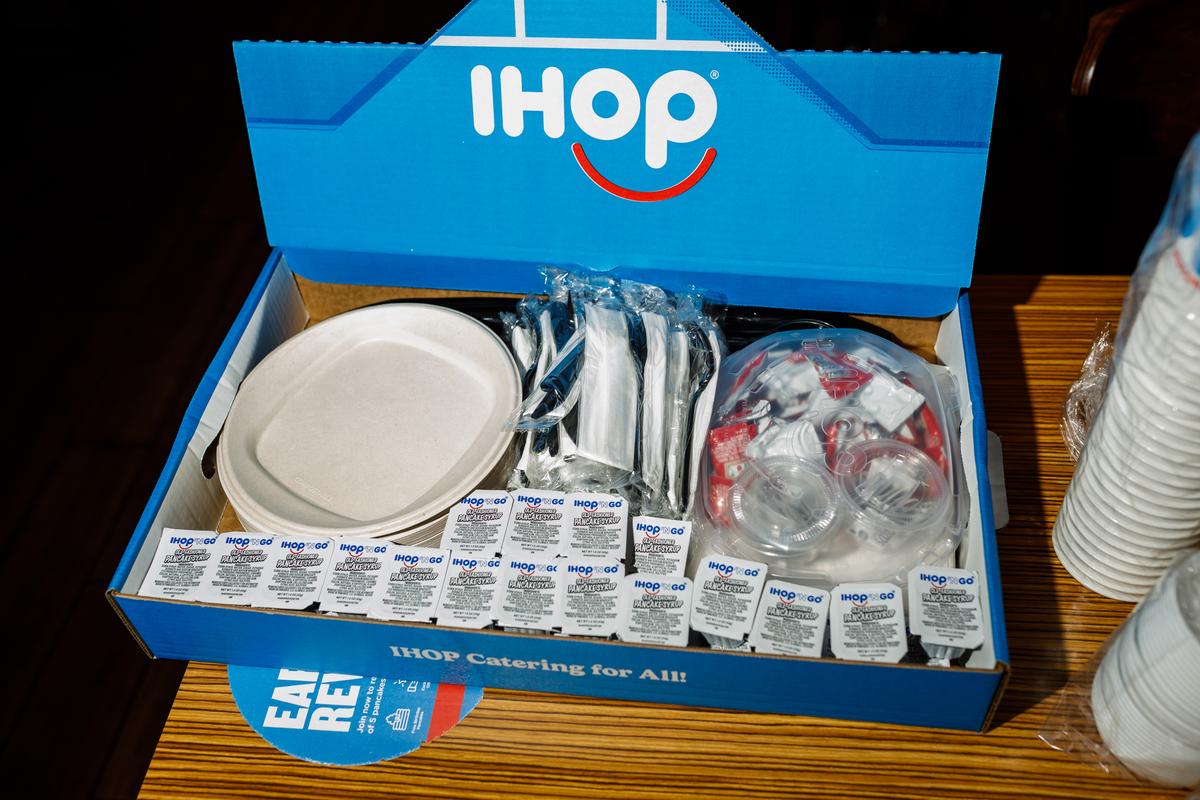 A catering box from IHOP, with plates, utensils, butter and syrup, in Union City, N.J., April 2, 2026. Restaurants like IHOP, Cracker Barrel and Red Lobster have found a new revenue source as return-to-office hits full force. (Brian Fraser/The New York Times)