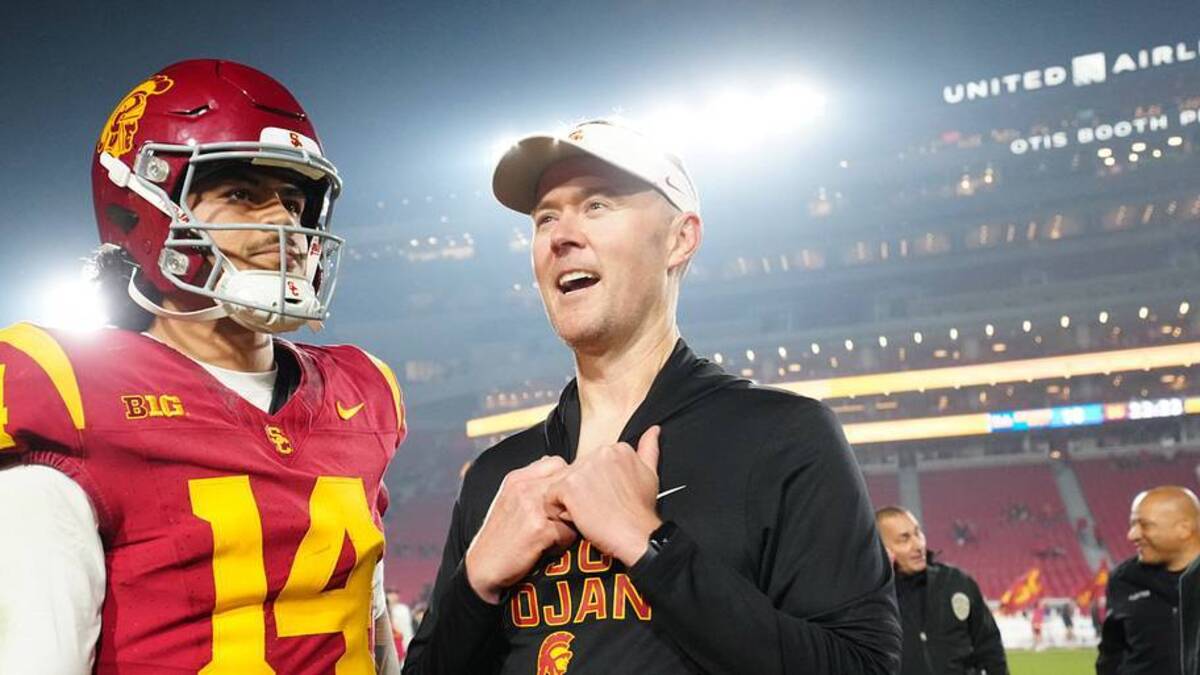  Nov 29, 2025; Los Angeles, California, USA; Southern California Trojans quarterback Jayden Maiava (14) and head coach Lincoln Riley react after the game against the UCLA Bruins at United Airlines Field at Los Angeles Memorial Coliseum. Mandatory Credit: Kirby Lee-Imagn Images | IMAGN IMAGES via Reuters Connect 