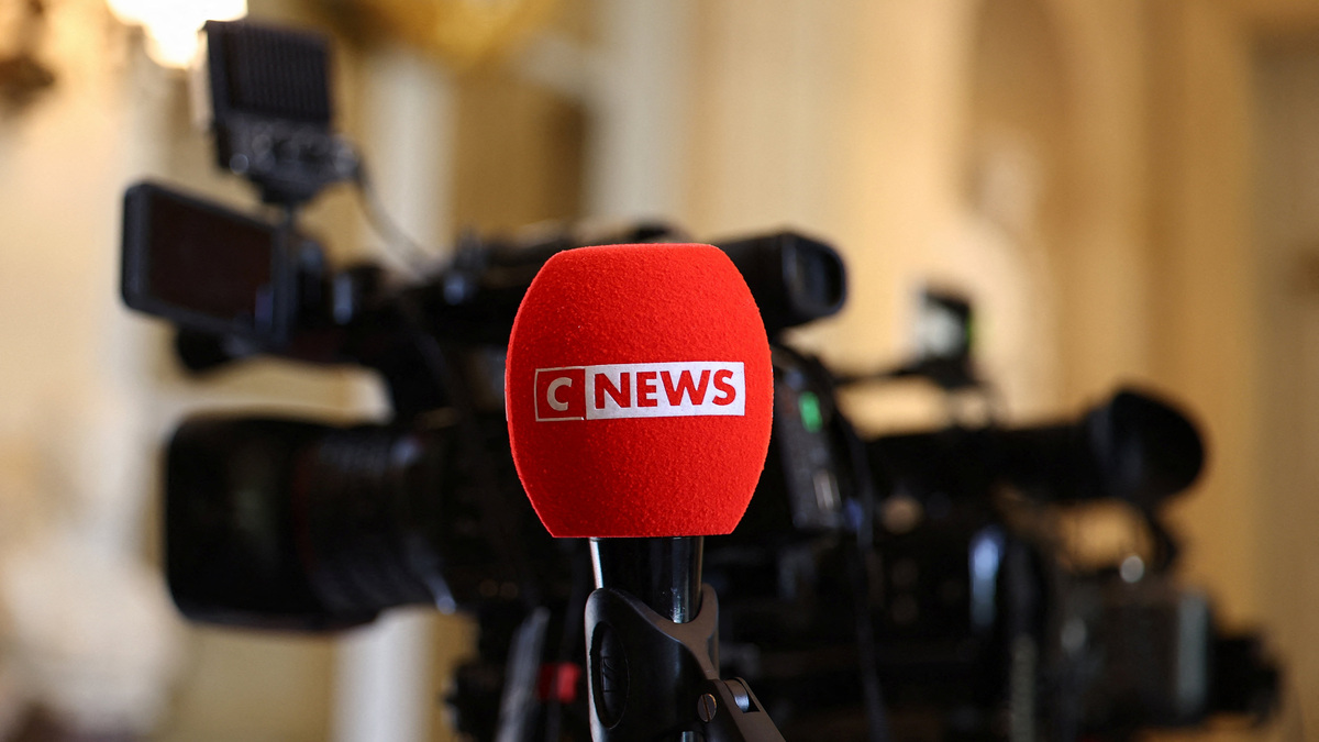 The logo of CNEWS, a French private national 24-hour news television channel, is seen on a microphone as journalists work at the National Assembly in Paris, France, April 27, 2026. REUTERS/Abdul Saboor