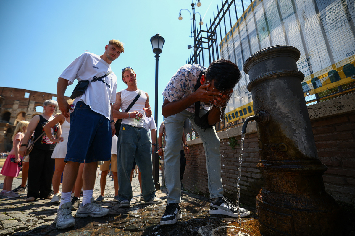 A person cools off from a public fountain near the Colosseum during a heatwave in Rome, Italy, June 20, 2026. REUTERS/Guglielmo Mangiapane