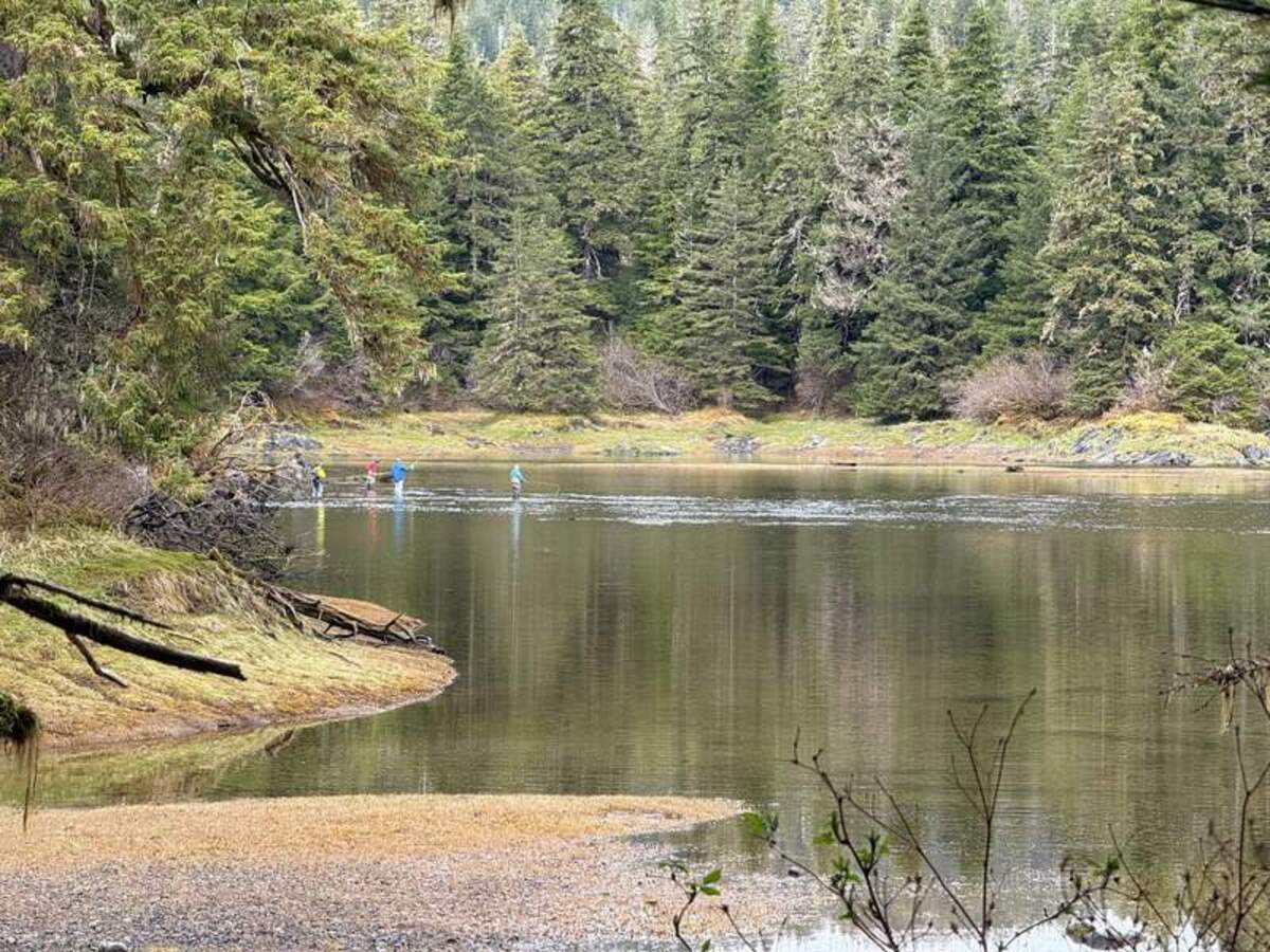  Secluded Eva Lagoon shimmers with the muted reflection of the surrounding forest. Photo credit: Mimi Slawoff 