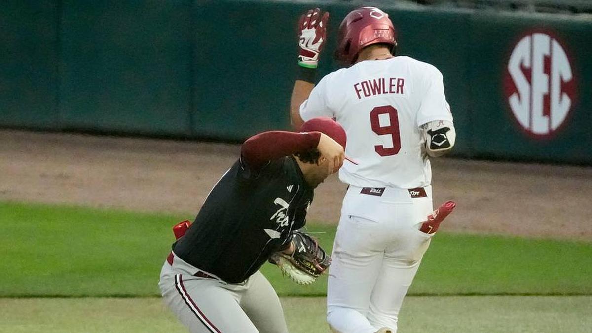  March 10, 2026; Tuscaloosa, AL, USA; Alabama batter Bryce Fowler (9) is safe after Troy first baseman Blake Cavill is pulled off the base by the throw at Sewell-Thomas Stadium. | Gary Cosby Jr. / USA TODAY NETWORK via Imagn Images 