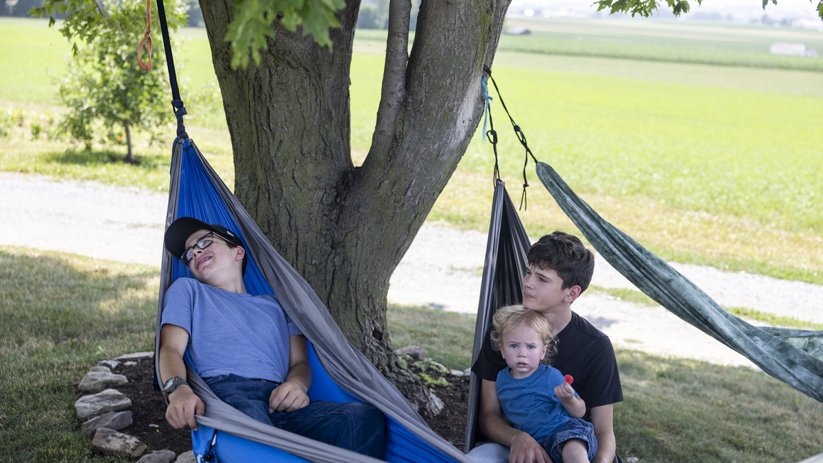 Gina and Shawn King's sons relax in hammocks after being cooped up inside with measles for several days in Lancaster County, Pennsylvania. (Tyger Williams/The Philadelphia Inquirer/TNS)