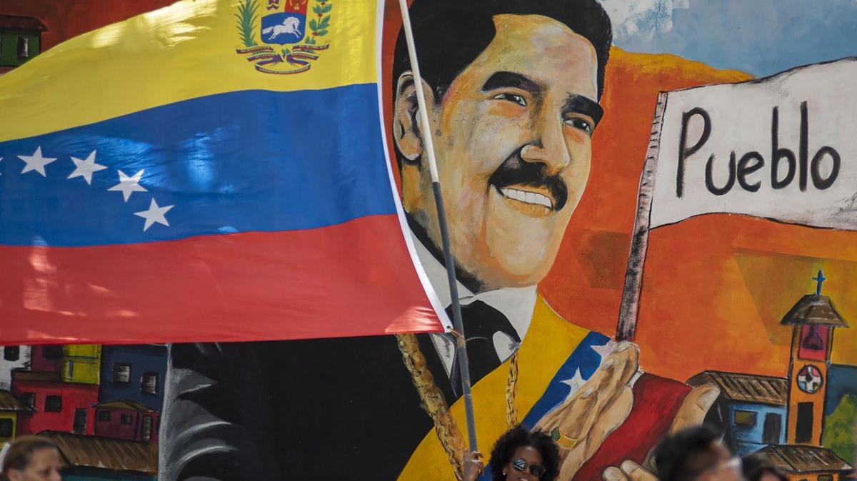 Supporters of ousted Venezuela President Nicolas Maduro carry a flag during a rally outside the National Assembly in Caracas, Venezuela, in January. The U.S. Department of Treasury has allowed Maduro and his wife, Celia Flores, to use funds from the Venezuelan government to pay their legal fees. File Photo by Jonathan Lanza/UPI