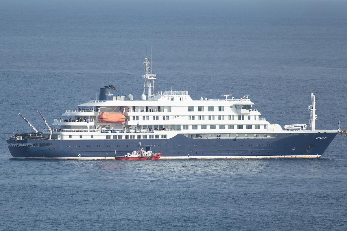  An ambulance boat carrying crew members wearing hazmat suits is shown approaching the MV Hondius in Cape Verde on May 5. 