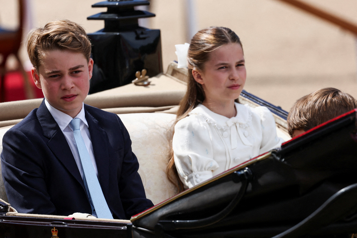 FILE PHOTO: Britain's Prince George, Princess Charlotte, and Prince Louis ride in a carriage during the Trooping the Colour parade to honour Britain's King Charles, as part of the official birthday celebrations, in London, Britain, June 13, 2026. REUTERS/Toby Melville/File Photo