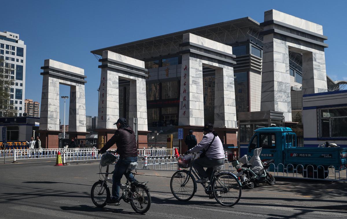 People ride bicycles by the entrance to the Inner Mongolia University of Science and Technology in China’s rare earth industry hub city Baotou, Inner Mongolia, China, April 6, 2026. REUTERS/Maxim Shemetov