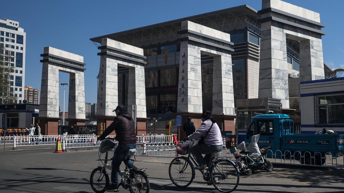 People ride bicycles by the entrance to the Inner Mongolia University of Science and Technology in China’s rare earth industry hub city Baotou, Inner Mongolia, China, April 6, 2026. REUTERS/Maxim Shemetov