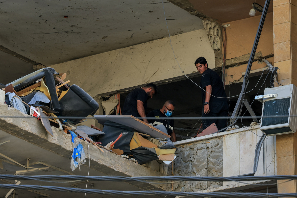 People inspect the damage inside a building following an Israeli strike on the southern suburbs of Beirut, Lebanon, June 7, 2026.
