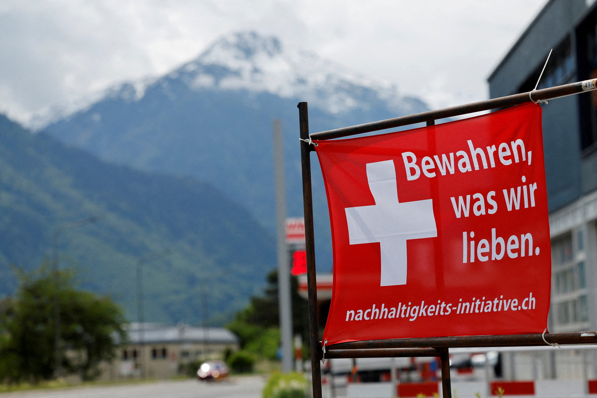 A sign is pictured ahead of a June 14 vote on a plan backed by the right-wing Swiss People's Party (SVP) to cap the population at 10 million inhabitants, in Glarus, Switzerland, May 18, 2026. The sign reads: "Preserve what we love". REUTERS/Stefan Wermuth