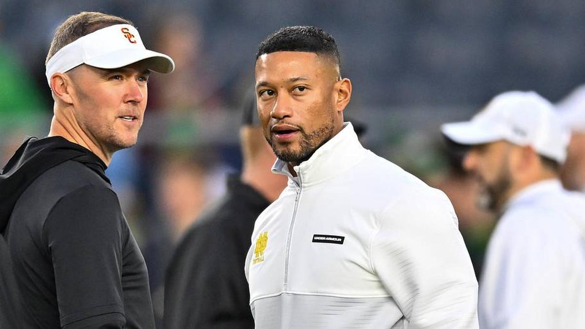  Oct 14, 2023; South Bend, Indiana, USA; USC Trojans head coach Lincoln Riley and Notre Dame Fighting Irish head coach Marcus Freeman chat before the game at Notre Dame Stadium. Mandatory Credit: Matt Cashore-Imagn Images | Matt Cashore-Imagn Images 
