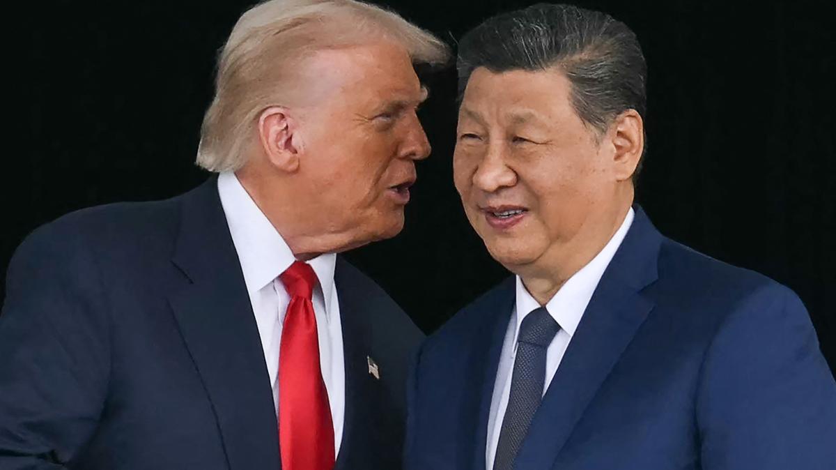 U.S. President Donald Trump, left, talks to China's President Xi Jinping as they shake hands after their talks at the Gimhae Air Base, located next to the Gimhae International Airport in Busan on Oct. 30, 2025. (Andrew Caballero-Reynolds/AFP/Getty Images/TNS)