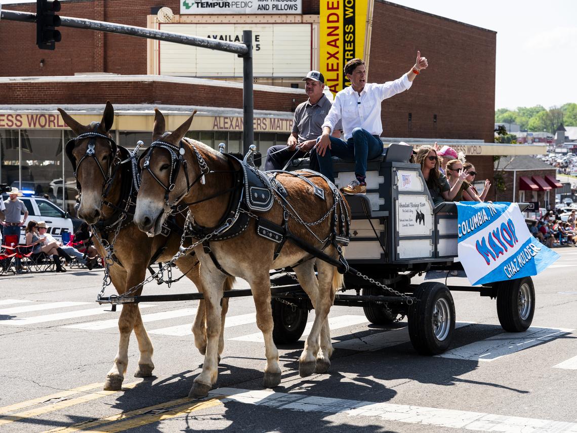 Chaz Molder, the mayor of Columbia and a Democratic House candidate, rides on a wagon during the town's annual Mule Day parade in Columbia, Tenn., April 11, 2026. "We need to be a little nicer," said Molder, the mayor of Columbia, Tenn., who hopes to show that Democrats can break through with rural voters. (Brad J. Vest/The New York Times)