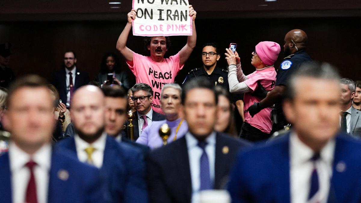 A protester holds a banner opposing the war with Iran during U.S. Defense Secretary Pete Hegseth's opening remarks at a Senate Armed Services Committee hearing on U.S. President Donald Trump's FY2027 budget request for the Department of Defence on Capitol Hill in Washington, D.C., April 30. REUTERS/Eric Lee