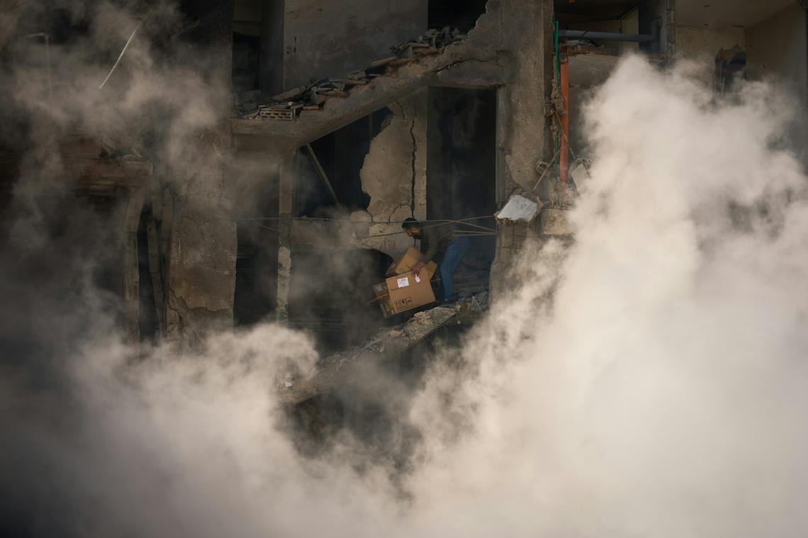  A Lebanese man gathers his belongings from his home, which was destroyed in an Israeli airstrike a day after the ceasefire with Iran went into effect. AP Photo/Emilio Morenatti 