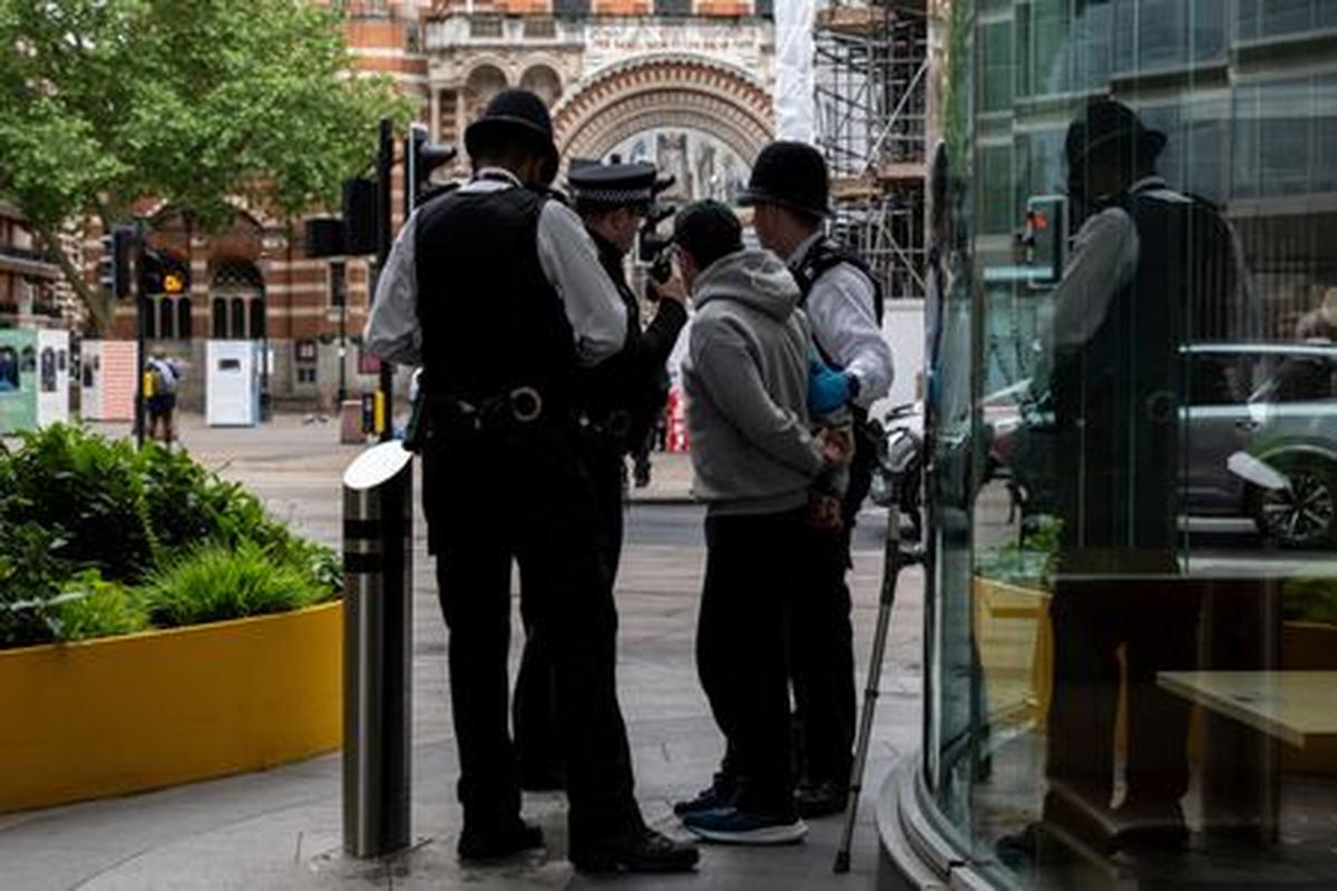 Police officers make an arrest after an alert from the Metropolitan Police live facial recognition operation in London, Britain, May 11, 2026. REUTERS/Chris J. Ratcliffe