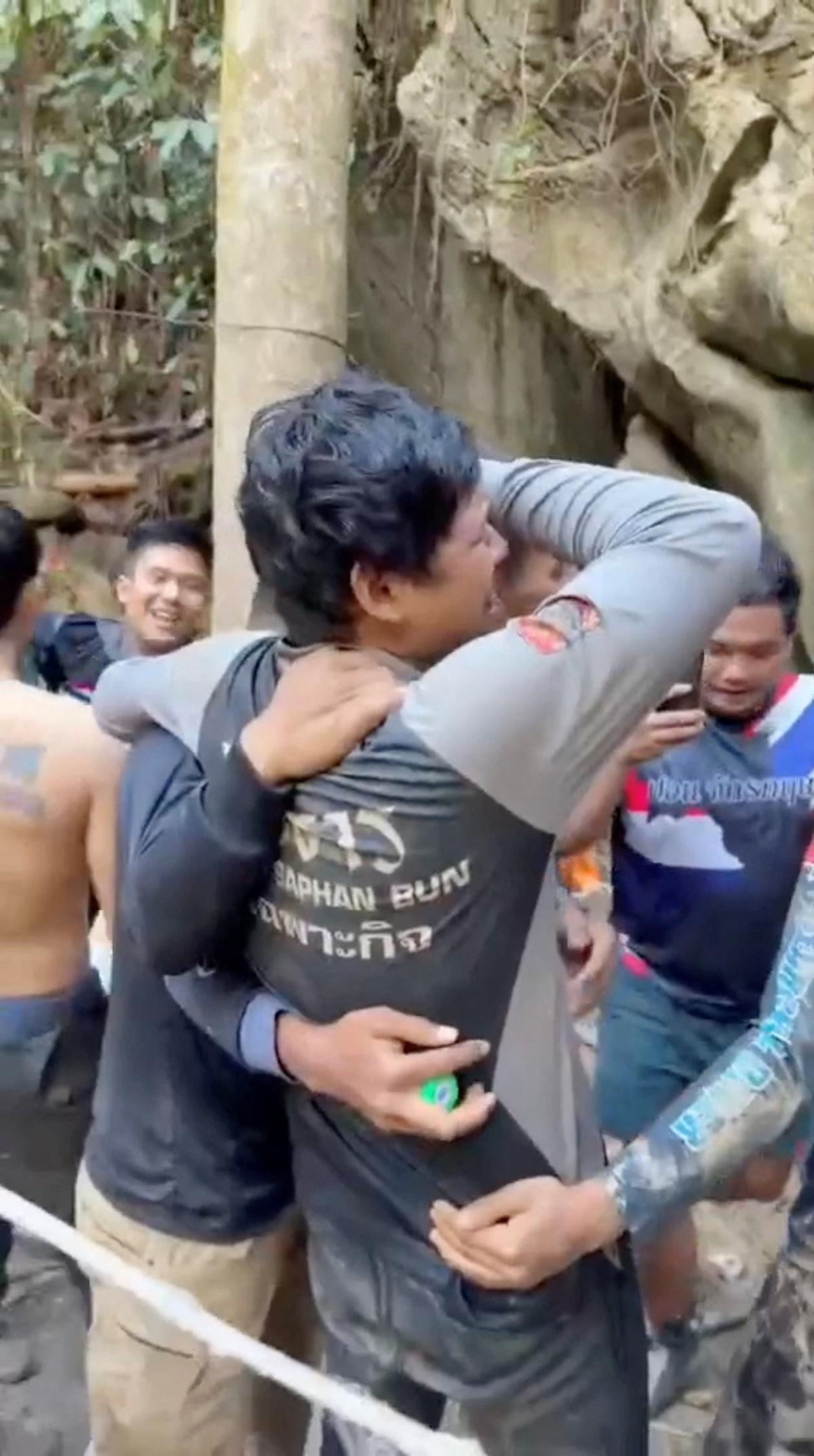 Members of a rescue team celebrate after announcing that they have found people trapped in a cave, in Xaisomboun Province, Laos, May 27, 2026, in this screengrab taken from a handout video. Metta Tham Kalasin Rescue/Handout via REUTERS