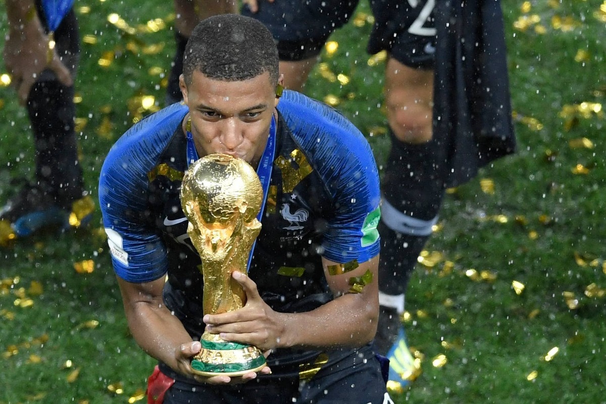  France's forward Kylian Mbappe kisses the trophy after winning the Russia 2018 World Cup final Photo by GABRIEL BOUYS/AFP via Getty Images