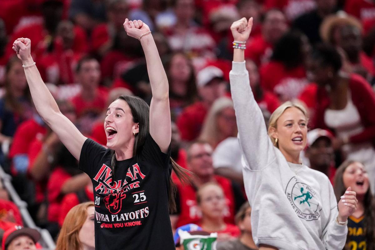  Indiana Fever guard Caitlin Clark and teammate Sophie Cunningham cheers from the bench Grace Smith/IndyStar / USA TODAY NETWORK via Imagn Images