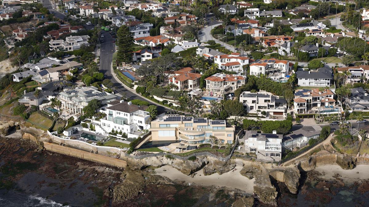 In an aerial photo, luxury homes line the coast of La Jolla. The tan oceanfront home  on Camino De La Costa sold for $47 million. (K.C. Alfred / The San Diego Union-Tribune)