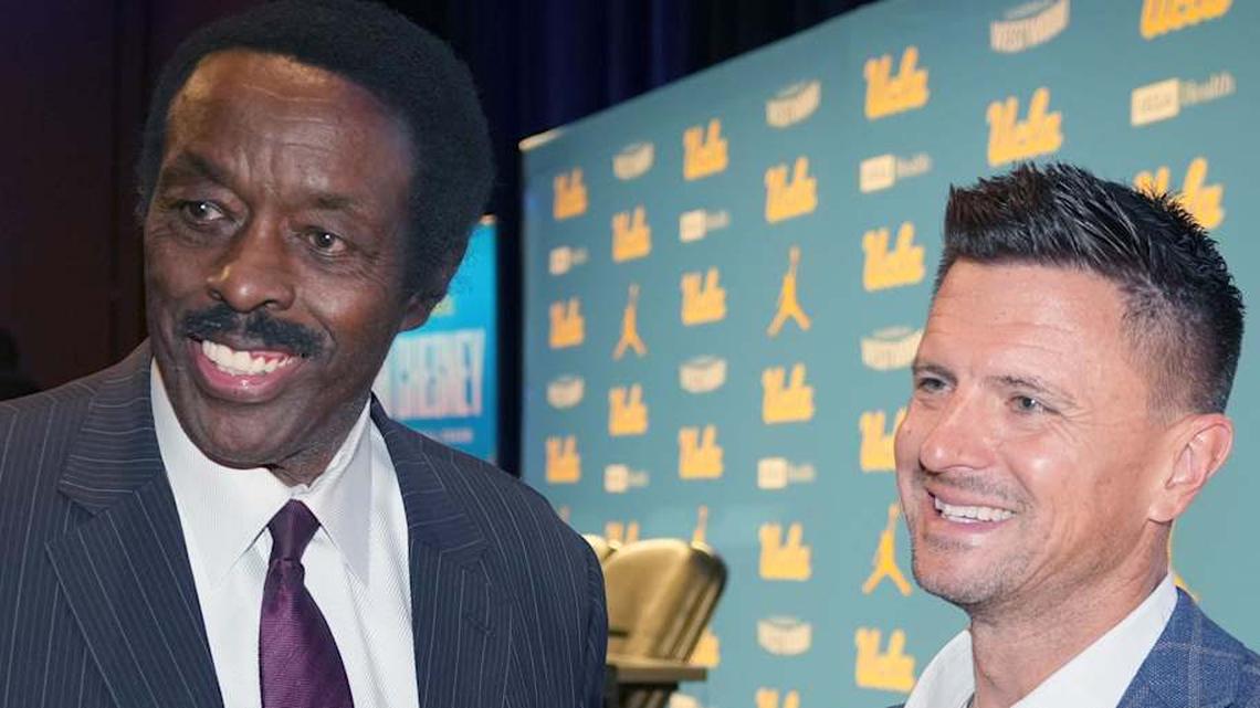  Dec 9, 2025; Los Angeles, CA, USA; UCLA Bruins football coach Bob Chesney (right) with CBS Los Angeles sports director Jim Hill at introductory press conference at Renee Luskin Conference Center Centennial Ballroom. Mandatory Credit: Kirby Lee-Imagn Images | Kirby Lee-Imagn Images 