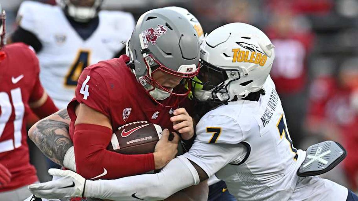  Washington State Cougars quarterback Zevi Eckhaus (4) is tackled by Toledo Rockets safety Emmanuel McNeil-Warren (7) in the second half at Gesa Field at Martin Stadium. | James Snook-Imagn Images 