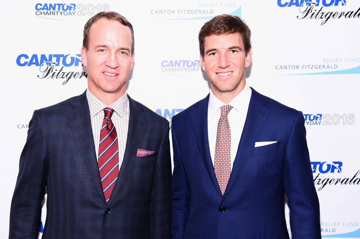  NEW YORK, NY - SEPTEMBER 12: Former NFL player Peyton Manning and NY Giants, NFL player Eli Manning attend the Annual Charity Day hosted by Cantor Fitzgerald, BGC and GFI at Cantor Fitzgerald on September 12, 2016 in New York City. (Photo by Dave Kotinsky/Getty Images for Cantor Fitzgerald) 