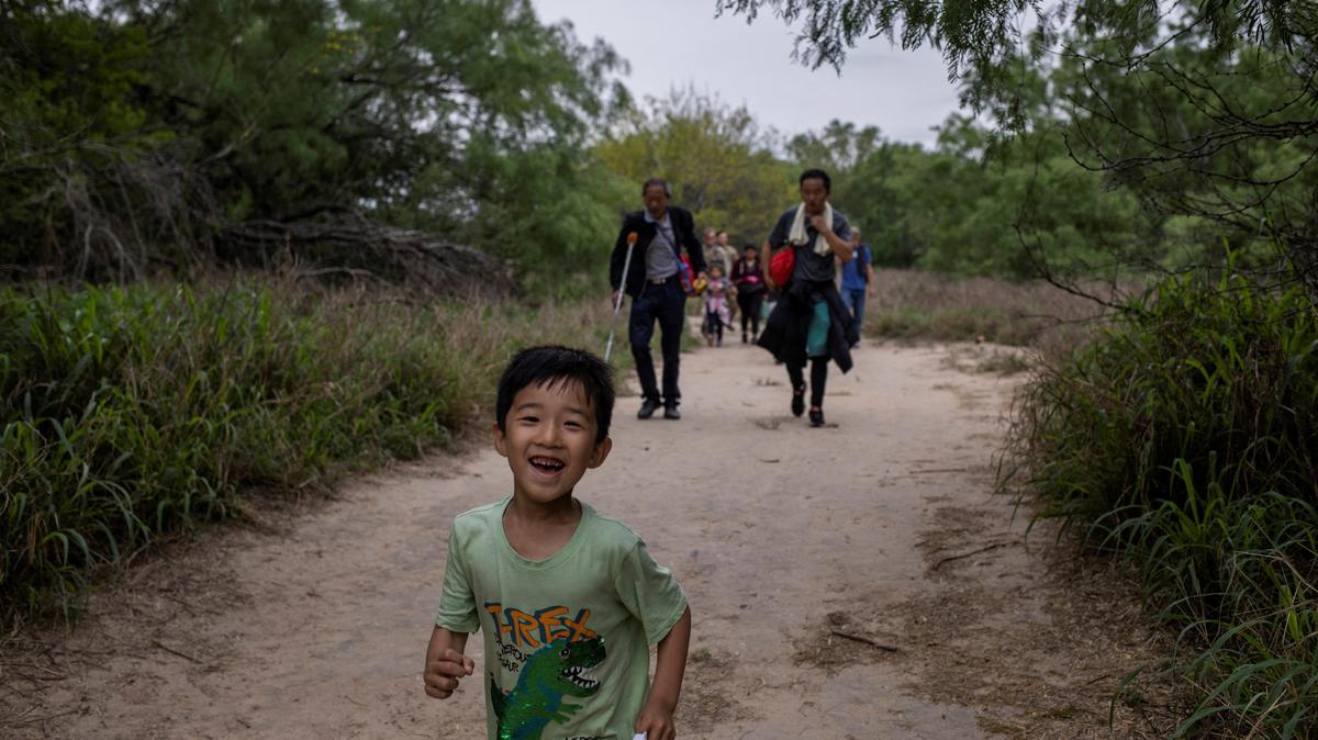 FILE PHOTO: A five-year-old migrant boy from China chases his brother down a trail after he and his family crossed the Rio Grande river into the United States from Mexico in Fronton, Texas, U.S., April 5, 2023.       REUTERS/Staff/File Photo