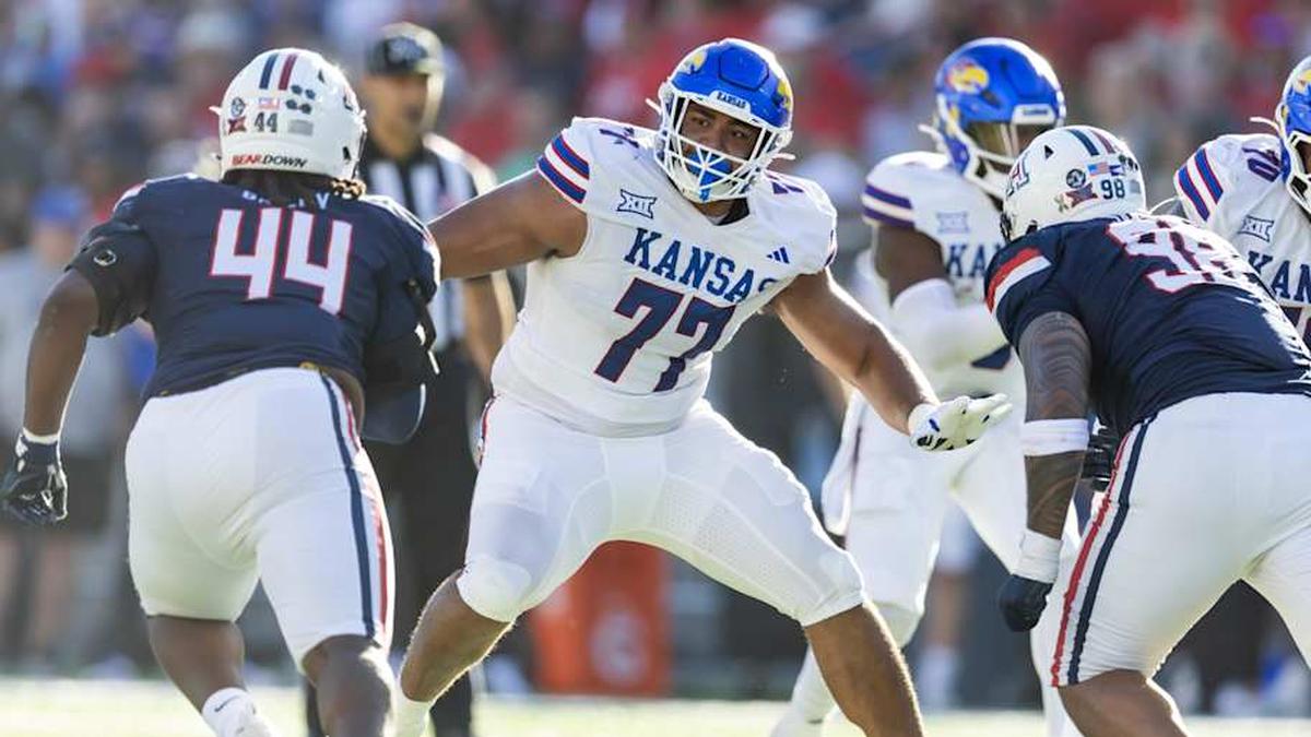  Nov 8, 2025; Tucson, Arizona, USA; Kansas Jayhawks offensive lineman Enrique Cruz Jr. (77) against the Arizona Wildcats at Arizona Stadium. Mandatory Credit: Mark J. Rebilas-Imagn Images | Mark J. Rebilas-Imagn Images 