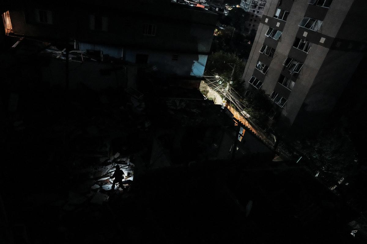 Emergency personnel work at the site where a fire set off by a potential gas explosion damaged homes and injured people, according to the local fire department, in Sao Paulo, Brazil, May 11, 2026. REUTERS/Alexandre Meneghini
