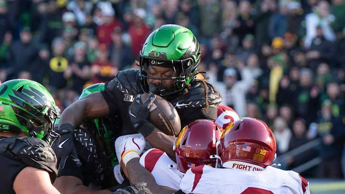  Oregon running back Noah Whittington is picked up by the offense and defense as the Oregon Ducks host the USC Trojans on Nov. 22, 2025, at Autzen Stadium in Eugene, Oregon. | Ben Lonergan/The Register-Guard / USA TODAY NETWORK via Imagn Images 