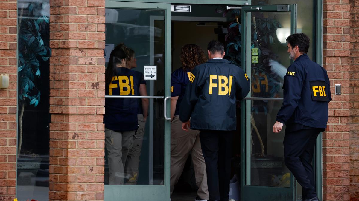 FBI personnel enter the building adjacent to The Cannabis Outlet on High Street in Portsmouth, Virginia, after serving a search warrant on Wednesday, May 6, 2026. (Peter Casey/The Virginian-Pilot/TNS)