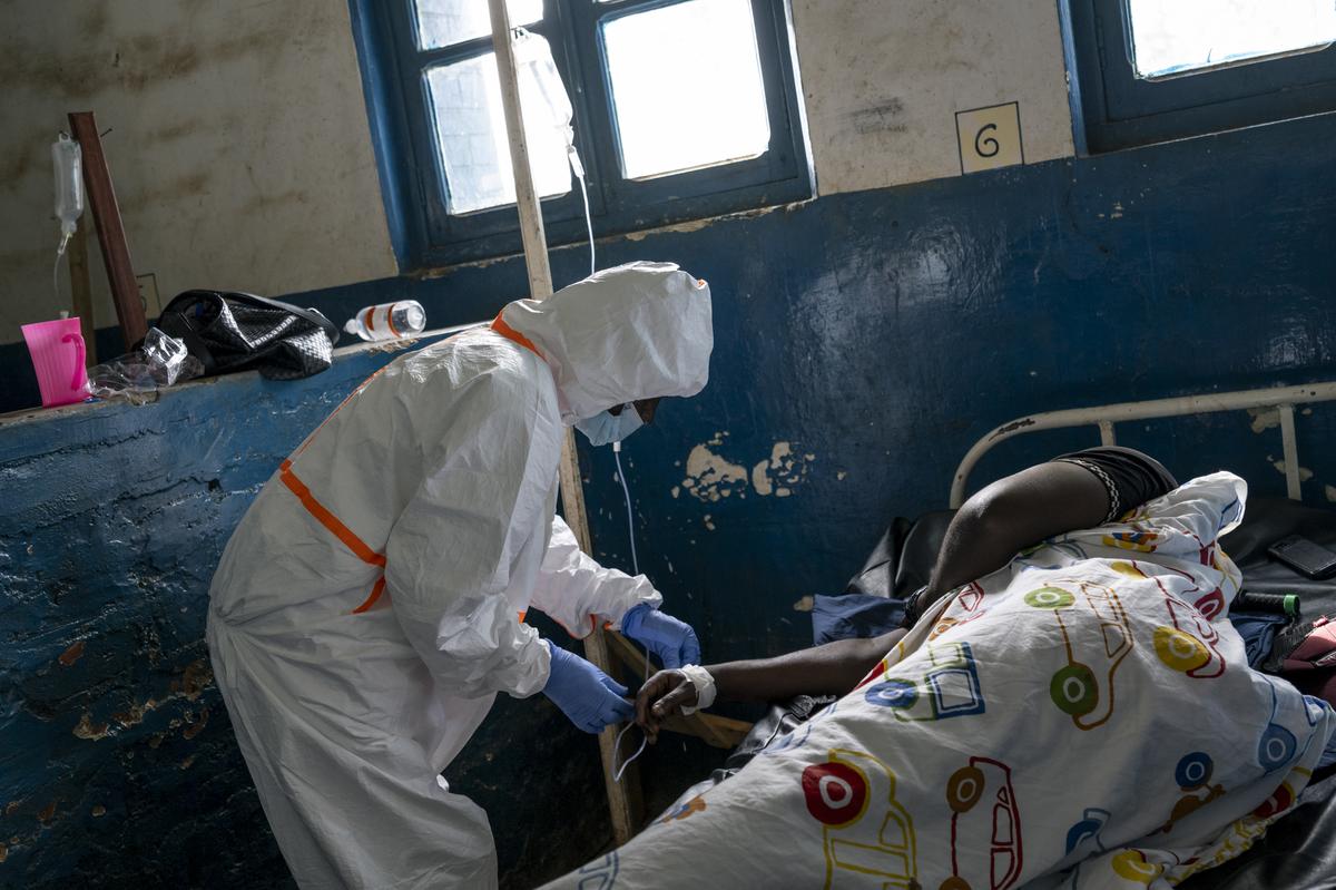 A health worker treats a patient at a hospital's Ebola ward in the mining town of Mongbwalu, Democratic Republic of Congo, May 26, 2026. In a remote gold mining town at the epicenter of the Ebola outbreak, medical workers struggle to beat back a surge of deaths and infections. (Arlette Bashizi/The New York Times)