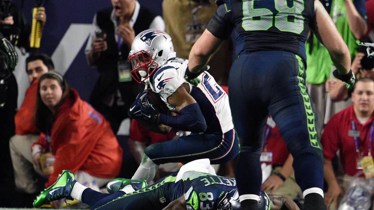 Feb 1, 2015; Glendale, AZ, USA; New England Patriots strong safety Malcolm Butler (21) intercepts the football against Seattle Seahawks wide receiver Ricardo Lockette (83) during Super Bowl XLIX at University of Phoenix Stadium. The Patriots defeated the Seahawks 28-24. Mandatory Credit: Kyle Terada-Imagn Images | Kyle Terada-Imagn Images 