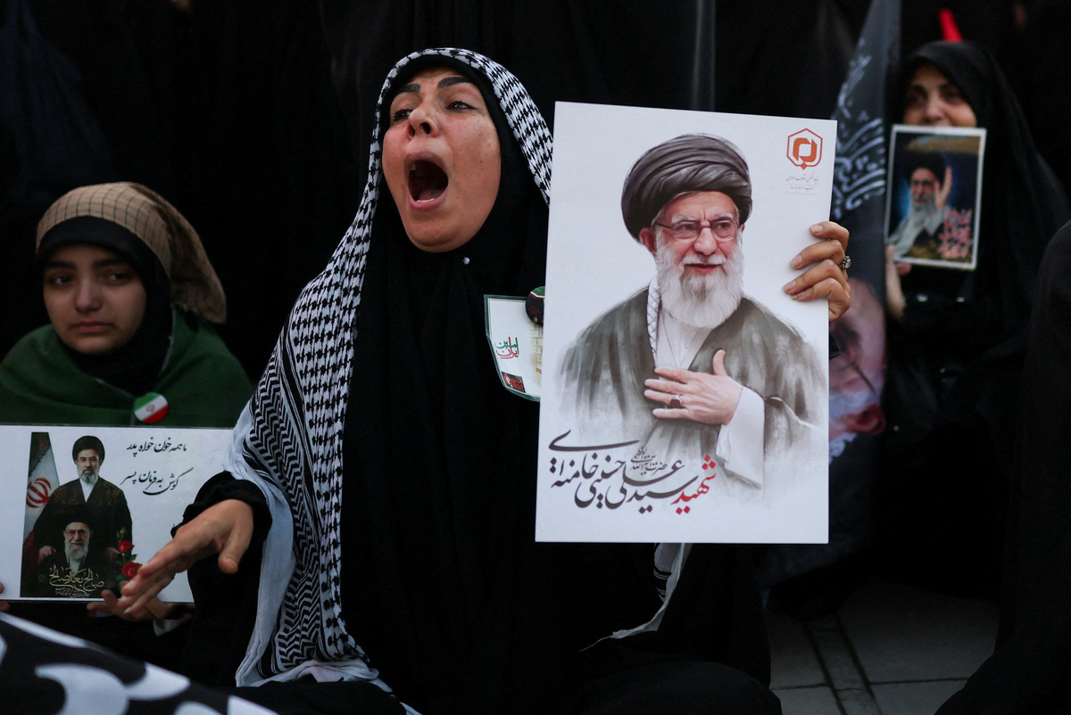 A woman reacts as she holds an image of late Supreme Leader Ayatollah Ali Khamenei, on the day of a public farewell ceremony to pay respects to Khamenei, who was killed on February 28 in Israeli and U.S. airstrikes, at the Imam Khomeini Grand Mosalla, in Tehran, Iran July 4, 2026.  REUTERS/Mohammed Salem