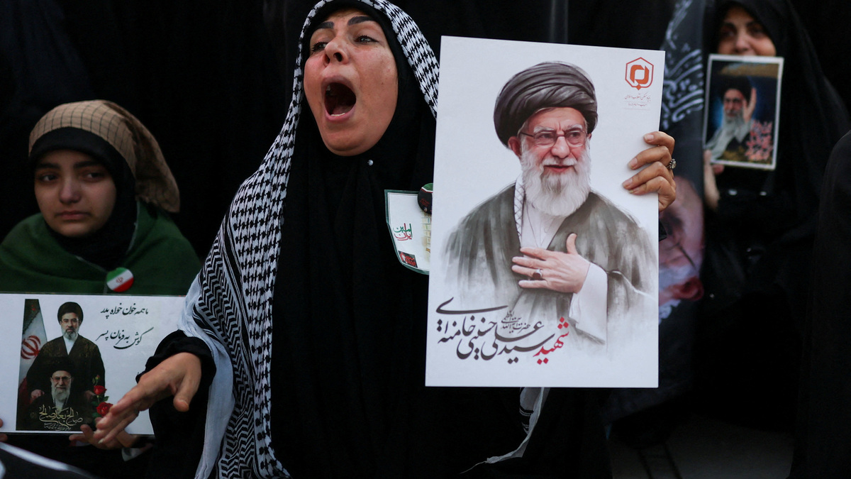 A woman reacts as she holds an image of late Supreme Leader Ayatollah Ali Khamenei, on the day of a public farewell ceremony to pay respects to Khamenei, who was killed on February 28 in Israeli and U.S. airstrikes, at the Imam Khomeini Grand Mosalla, in Tehran, Iran July 4, 2026.  REUTERS/Mohammed Salem