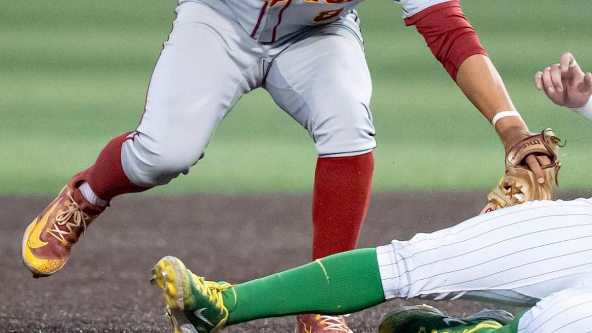  USC's Kevin Takeuchi, left, tags Oregon infielder Ryan Cooney as he slides to second as the Oregon Ducks host the USC Trojans on May 14, 2026, in Eugene, Oregon. | Ben Lonergan/The Register-Guard / USA TODAY NETWORK via Imagn Images 