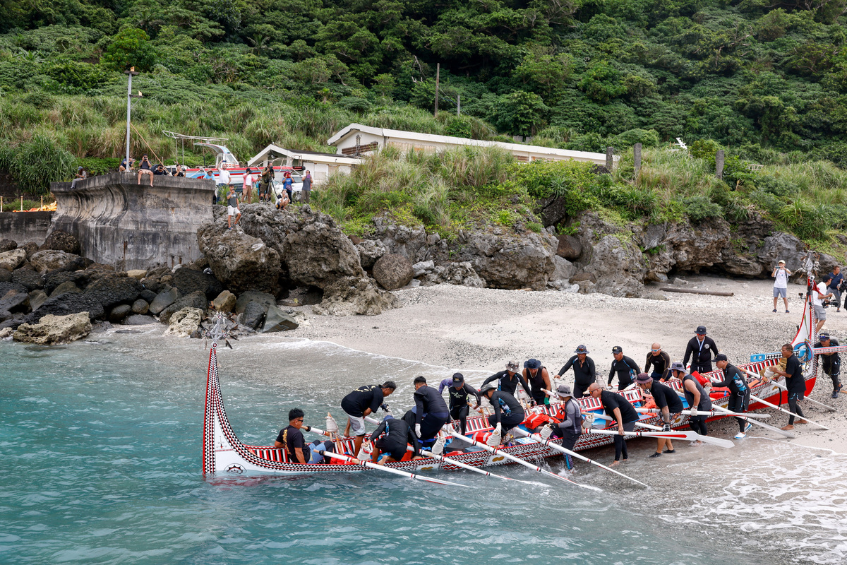 Tao indigenous rowers jump into a traditional wooden canoe named Ovayan, or "Golden Friendship," as they prepare to paddle to the Philippines' Batanes Islands, on Orchid Island, Taiwan, June 15, 2026. REUTERS/Ann Wang