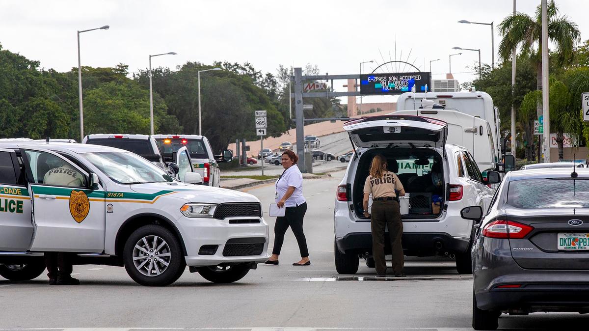 Police block an intersection near the Miami-Dade Kendall Campus in Miami, Fla., on Sunday, June 6, 2021. Three people are dead and at least six others injured following a shooting at a Florida graduation party, the latest in a string of such violence in the Miami area, police said Sunday. One of those killed was a state corrections officer, Miami-Dade police Director Freddie Ramirez told news outlets. (Daniel A Varela/Miami Herald via AP)