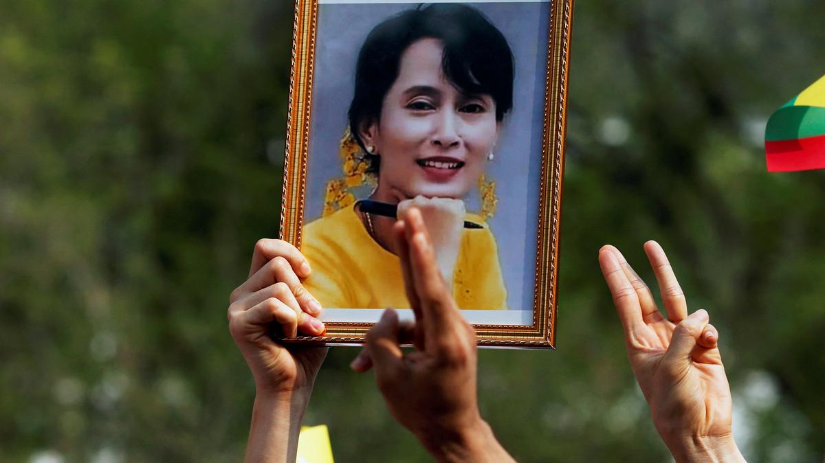 FILE PHOTO: A person holds a picture of leader Aung San Suu Kyi as Myanmar citizens protest against the military coup in front of the UN office in Bangkok, Thailand February 22, 2021. REUTERS/Soe Zeya Tun/File Photo