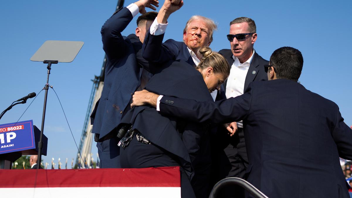 FILE -- A bloodied Donald Trump is escorted off by Secret Service agents after being shot in the ear, at a campaign rally in Butler, Pa, on Saturday, July 13, 2024. The photo was part of Doug Mill’s coverage of the shooting that earned the 2025 Pulitzer Prize for breaking news photography. (Doug Mills/The New York Times)