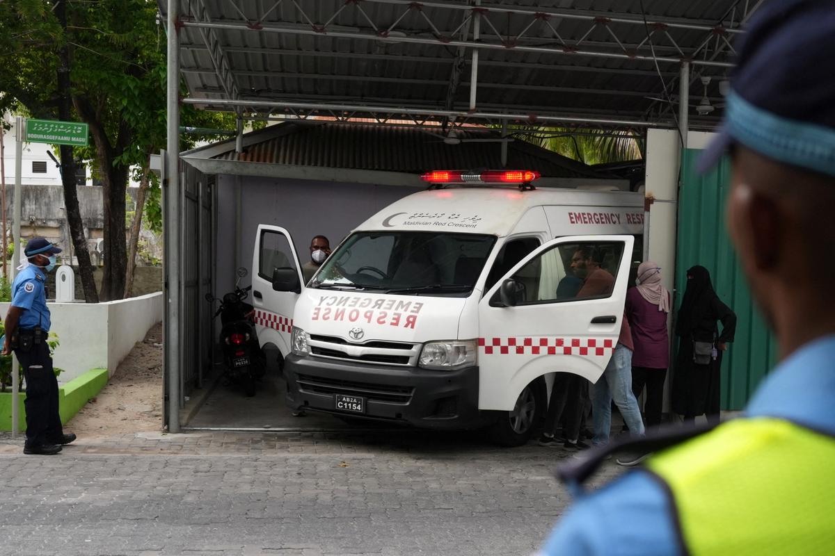 An ambulance carrying the body of one of the five Italian scuba divers who died in an accident in underwater caves, arrives at a mortuary in Male, Maldives, May 19, 2026. REUTERS/Thilina Kaluthotage