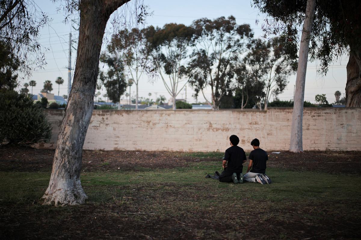 People pray during a vigil in a park, the day after a fatal shooting at the Islamic Center of San Diego, in San Diego, California, U.S., May 19, 2026. REUTERS/Daniel Cole