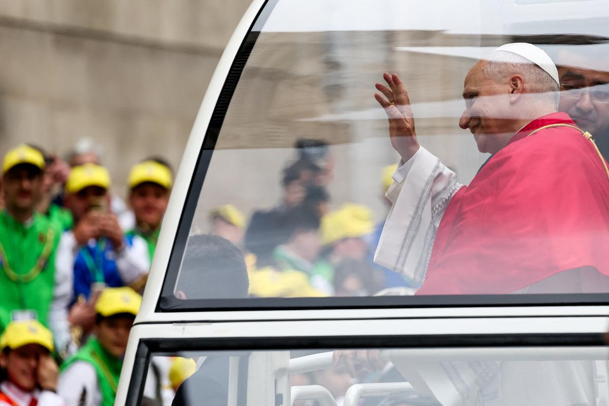 Pope Leo XIV waves as he arrives in Popemobile at the Naples Cathedral for a meeting with members of the clergy on the day of the first anniversary of his election, in Naples, Italy, May 8, 2026. REUTERS/Yara Nardi