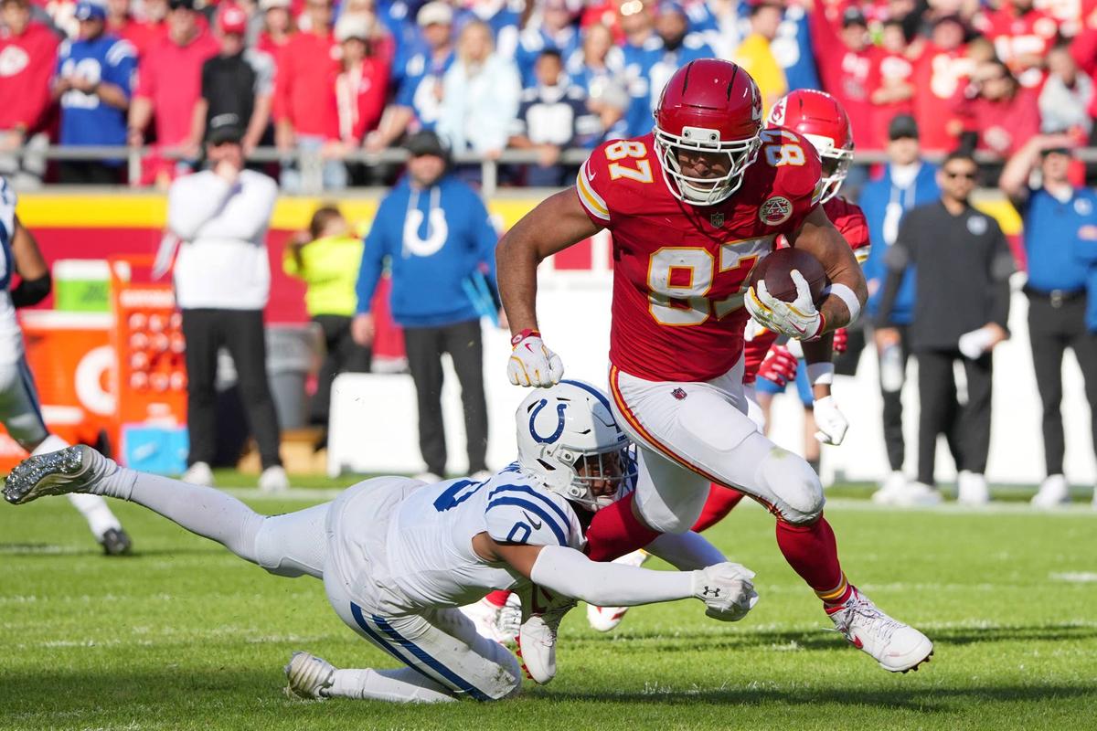  Indianapolis Colts safety Cam Bynum (0) tackles Kansas City Chiefs tight end Travis Kelce (87) in the first half at GEHA Field at Arrowhead Stadium. Denny Medley-Imagn Images