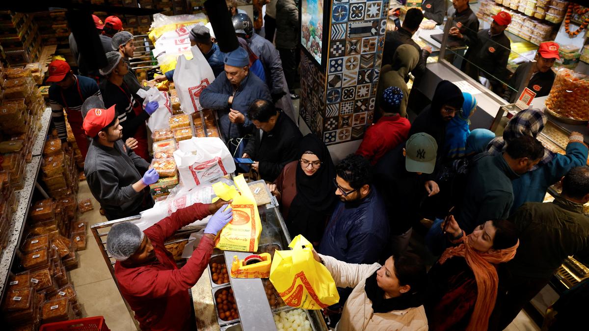 Kashmiri people buy bakery items and sweets at a shop ahead of the Eid al-Fitr, which marks the end of the Muslim fasting month of Ramadan, at a market area in Srinagar, Indian Kashmir, March 18, 2026.REUTERS/Sharafat Ali