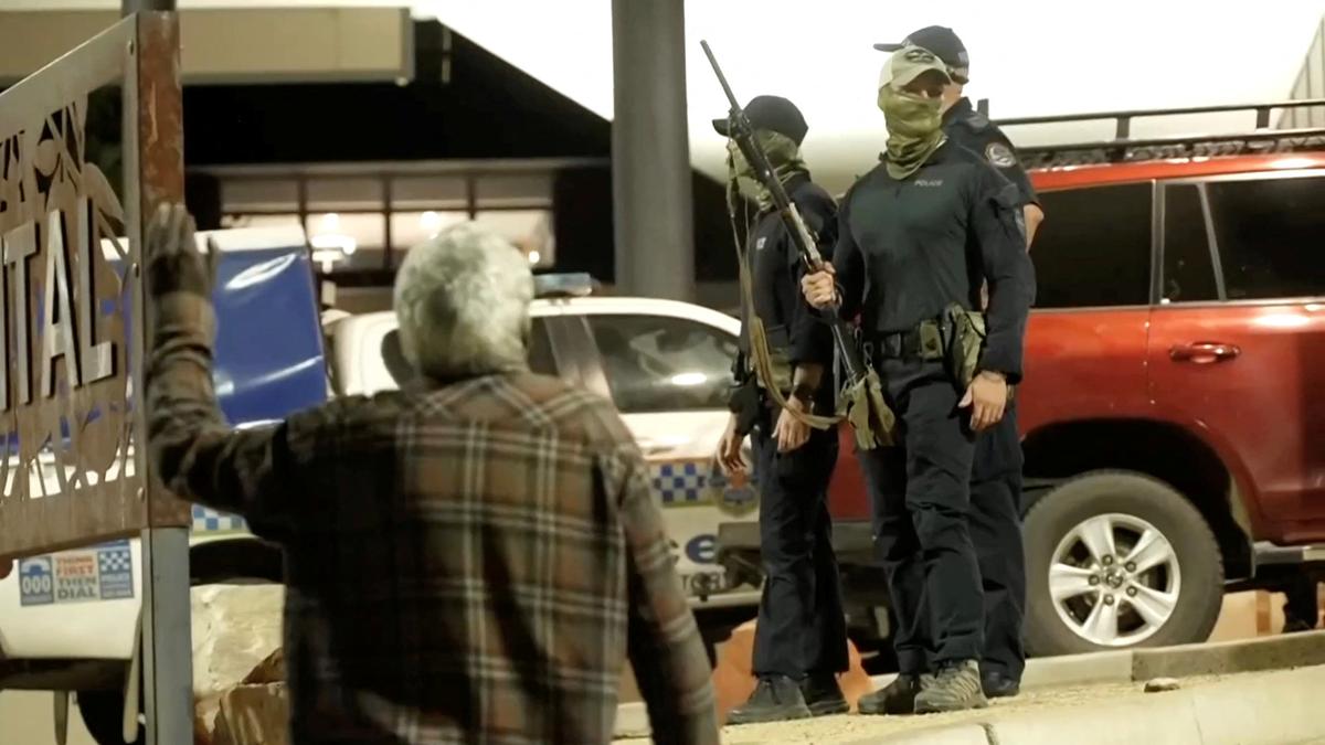A man gestures near police amidst community unrest outside Alice Springs Hospital, where a 47-year-old man arrested in connection with the alleged killing of five-year-old Kumanjayi Little Baby was taken, in Alice Springs, Australia, April 30, 2026, in this screengrab taken from a video. AUSTRALIAN BROADCASTING CORPORATION/via REUTERS