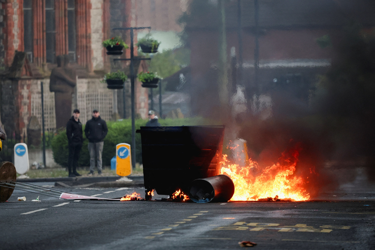 A fire burns during a protest after a knife attack on June 8 left a man seriously injured and prompted police to declare a critical incident, in Belfast, Northern Ireland, June 9, 2026. REUTERS/Isabel Infantes